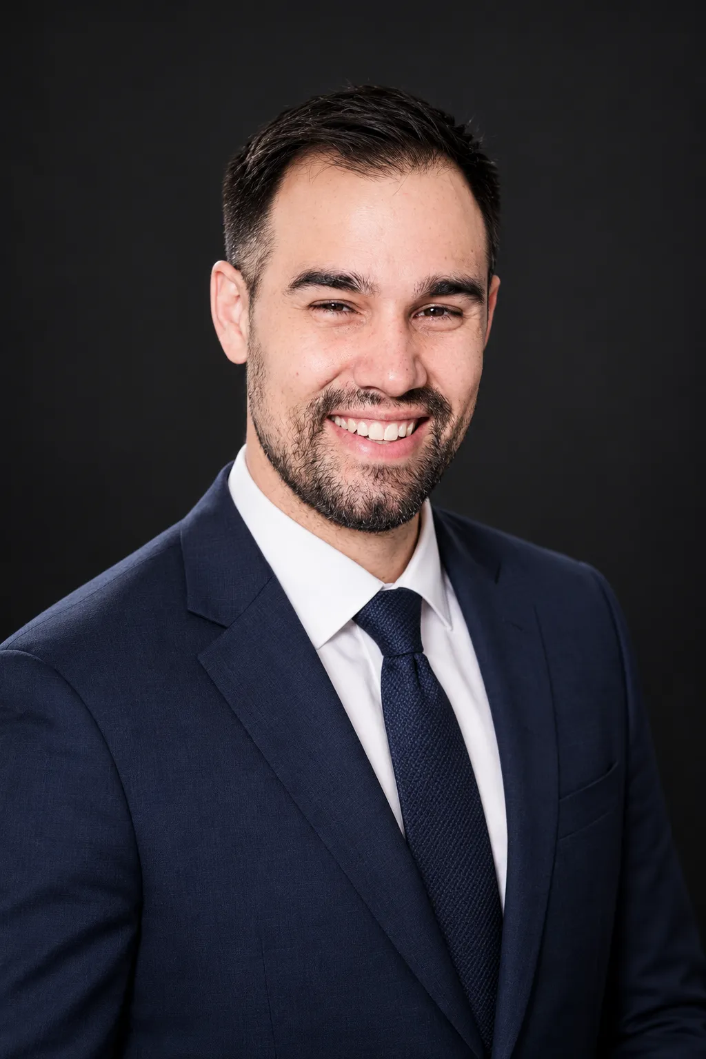The same man in a navy suit executive portrait