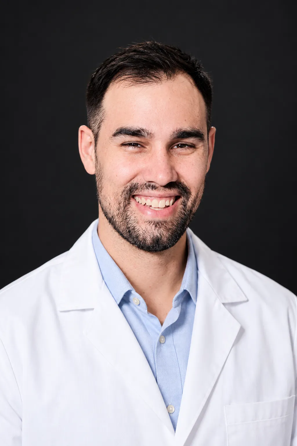 The same man in a white medical coat studio portrait
