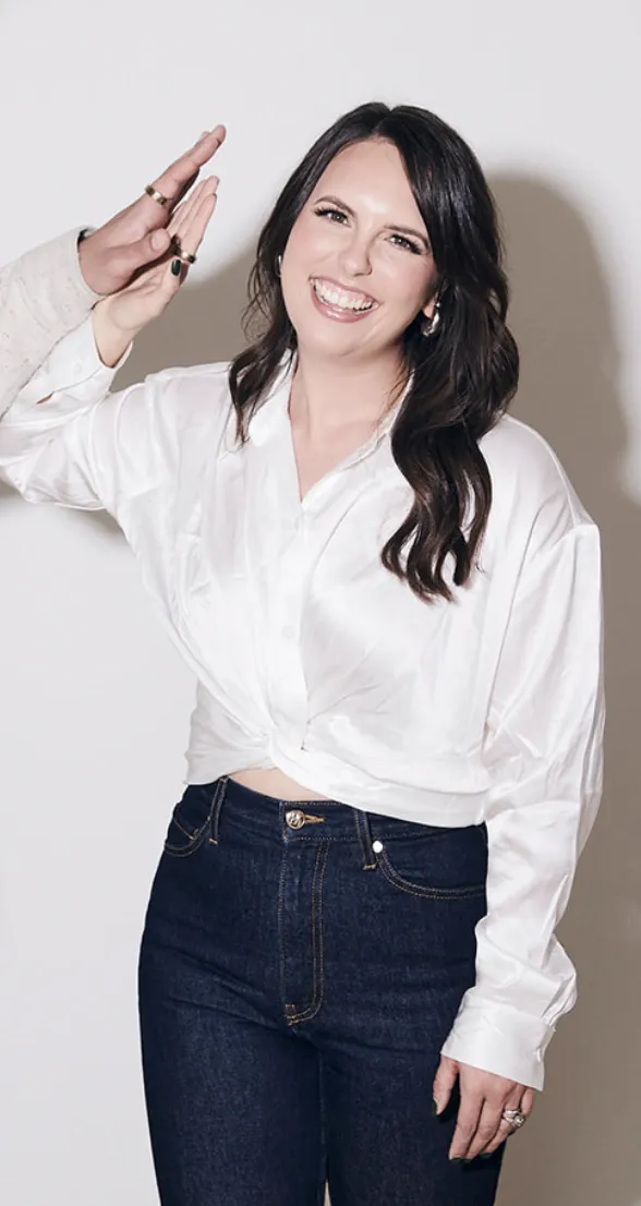A casual photo of a woman on a plain background